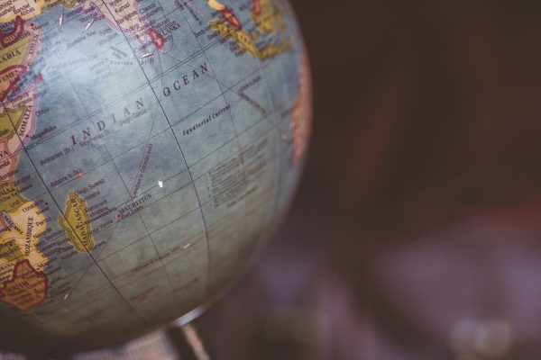 A vertical shot of a desk globe with a blurred background